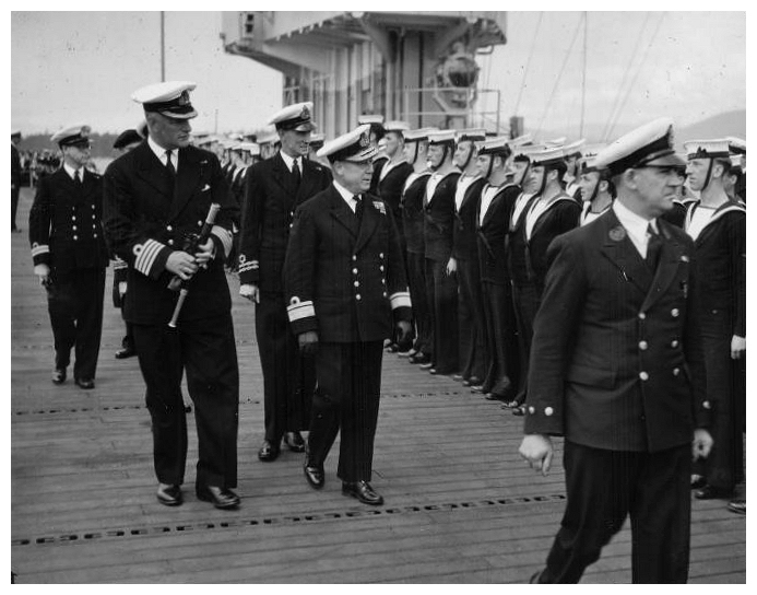 Rear Admiral V. G. Brodeur RCN & Senior Royal Navy Officers inspect the ships company after the Dedication Service aboard HMS Thane, Vancouver, June 44.[Photo: Ray Keena]